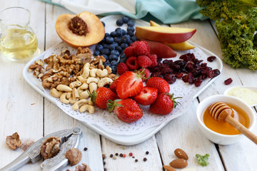 Nuts and berries. Ingridients. Blueberry, strawberry, plate, apple, apricot raspberry. Fresh. Organic. Vitamin. Breakfast. Healthy food. 