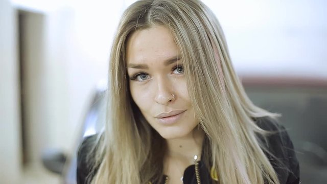 feminized blonde car service master girl looking at camera
