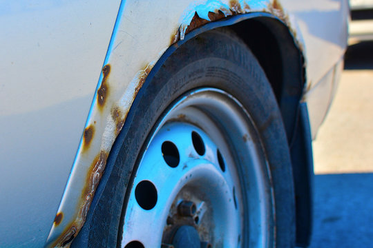 Fragment Of A Car With Rust. The Car Body Element Is Corroded. Concept: Corrosion Resistance, Car Body Repair, Rust Protection.