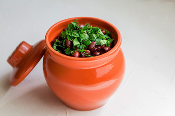 lobio is a Georgian national dish.Lobio, on white background, view from above.Boiled georgian beans or Lobio in a clay pot 
