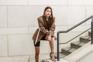 Portrait shooting of a stylish girl. Beige shades. Trends of spring and summer 2019. Bike shorts....