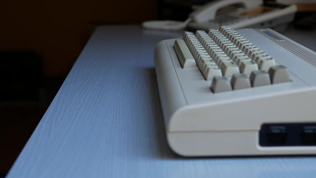 Man hand typing on old computer, slider shot