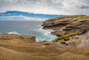 Ocean waves swirling around the unique lava rock formations of the Lanai Lookout on Oahu, Hawaii