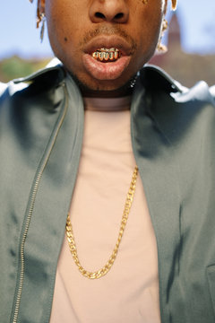 Crop black rapper with gold teeth