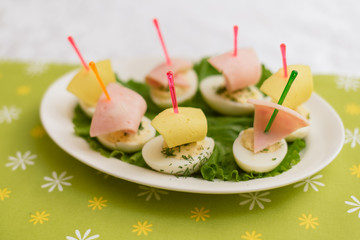 Children's food in the form of ships. Creative sandwiches of eggs in the form of ships. Children's menu on a green background