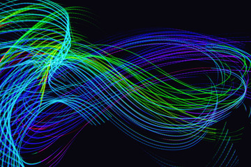 Abstract neon lights trails in the black background. Futuristic overlay light pattern.