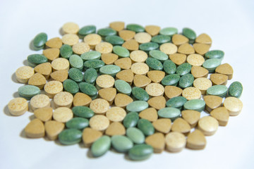 multicolored pills on white background