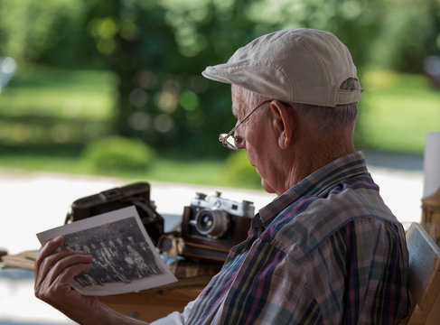 Senior man looking at old photos