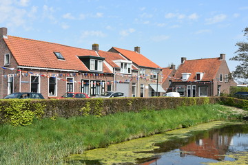 Street in village in Holland with 'Koningsdag' decoration.