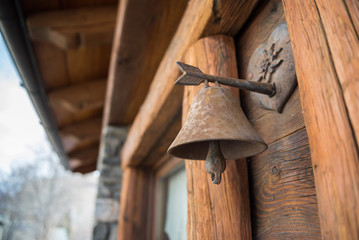 Obraz na płótnie Canvas Iron doorbell in a house in Italian mountains, Valle d'Aosta