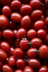 Red cherry tomato food background, close-up, top view. 