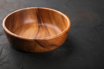 Tableware made of wood on a dark background.