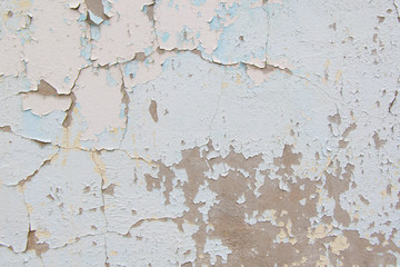 Old cement wall with cracked blue paint texture