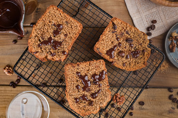 Cake with cocoa and chocolate on a wooden table. Sweet homemade pastries for breakfast. Rustic style photo.