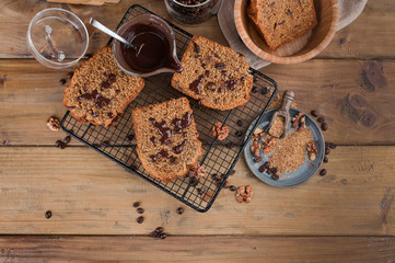 Cake with cocoa and chocolate on a wooden table. Sweet homemade pastries for breakfast. Rustic style photo.