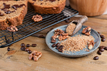 Cake with cocoa and chocolate on a wooden table. Sweet homemade pastries for breakfast. Rustic style photo.