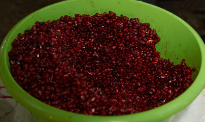 Close up of fresh organic pomegranate seeds background, top view