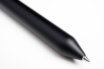 A close-up product shot of a sleek black barrel clicker ballpoint pen set on a plain white background.