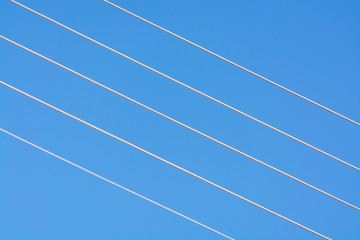 Empty music staff concept photo of 5 electric wires on blue sky, music creation template