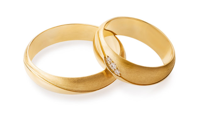 Gold wedding rings with diamonds isolated on white background. The photo was taken by stacking.