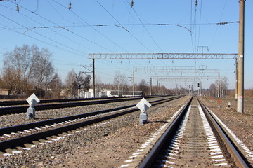 Fototapeta na wymiar Broad gauge railway tracks in perspective on a spring day - tourism, travel