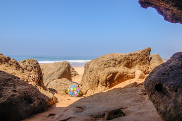 Fototapeta na wymiar beach ball and rocks
