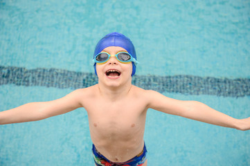 Fototapeta na wymiar close up photo of 7-year boy preparing to jump in the swiimming pool