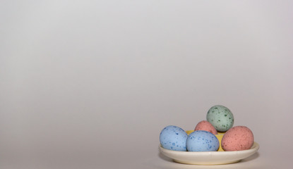 A bunch of small colorful Easter eggs on a white background