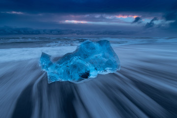 Iceland Jokulsarlon ice beach in winter sunrise with blue ice in slow exposure