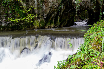 River getting out from a cave with high contrast