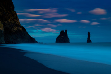 Iceland Reynisfjara vik beach in winter at blue hour after sunset  with pink clouds and slow capture of wave