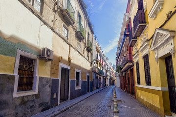 Fototapeta na wymiar Colorful buildings in street in Seville, Spain