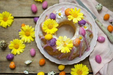 Fototapeta na wymiar Easter cake. A traditional donut marble cake with an easter decor. Easter eggs and spring flowers.