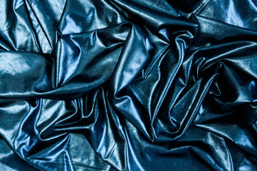 Black blue cloth waves abstract textile background. Fabric as pitch oil. Dark wallpaper.