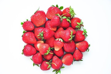 Red strawberries on a white background. Red berries. Berries for the cake. Strawberry basket. A group of berries. Fresh fruit and juicy fruit for fruit drink.