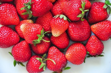 Red strawberries on a white background. Red berries. Berries for the cake. Strawberry basket. A group of berries. Fresh fruit and juicy fruit for fruit drink.