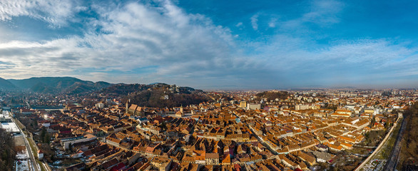 Obraz na płótnie Canvas Brasov, Transylvania. Romania. Panoramic view of the old town and Black Church in the old town square, Aerial twilight cityscape of Brasov city, Romania