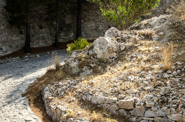 Crooked road going up a rocky mountain