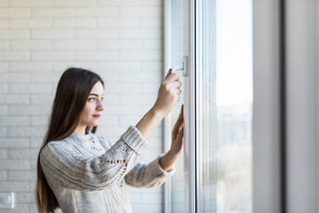 Young woman opening new modern window, closeup view