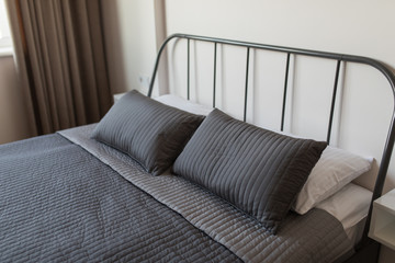White pillows on bed in modern bedroom design concept, interior decoration concept