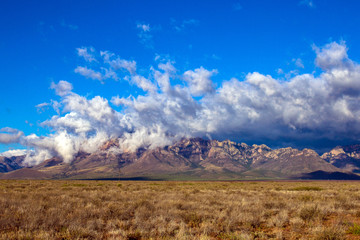 Arizona's Chiricahua Mountains under a large storm cloud