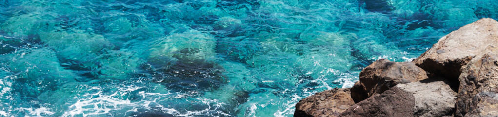 Clean blue turquoise sea and rocks	