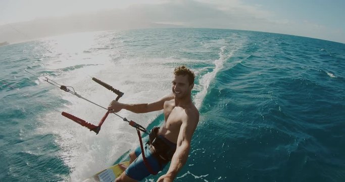 Young athletic man kitesurfing POV, extreme sports POV, tropical island surf adventure