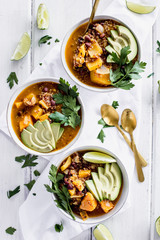 Overhead Top Down Chili Soup Tablascape with Avocado Slices Parsley Lime Sweet Potato Vegan Mexican Food