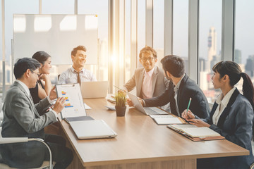 Businesspeople discussing together in conference room during meeting at office.