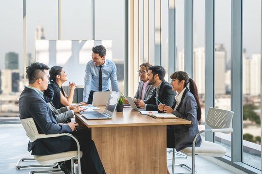 Businesspeople discussing together in conference room during meeting at office.