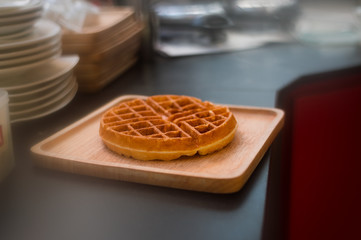 waffles with chocolate sauce on wooden plate. vintage concept