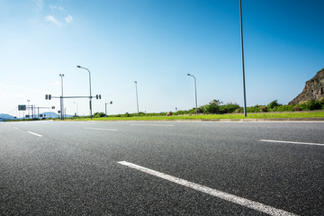 very long highway with three lane without cars