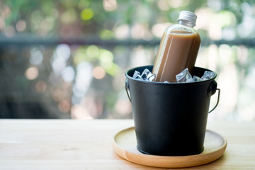 Coffee in plastic bottle served in ice bucket