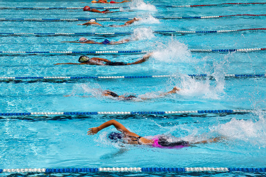 Athletes competing in the swimming pool.